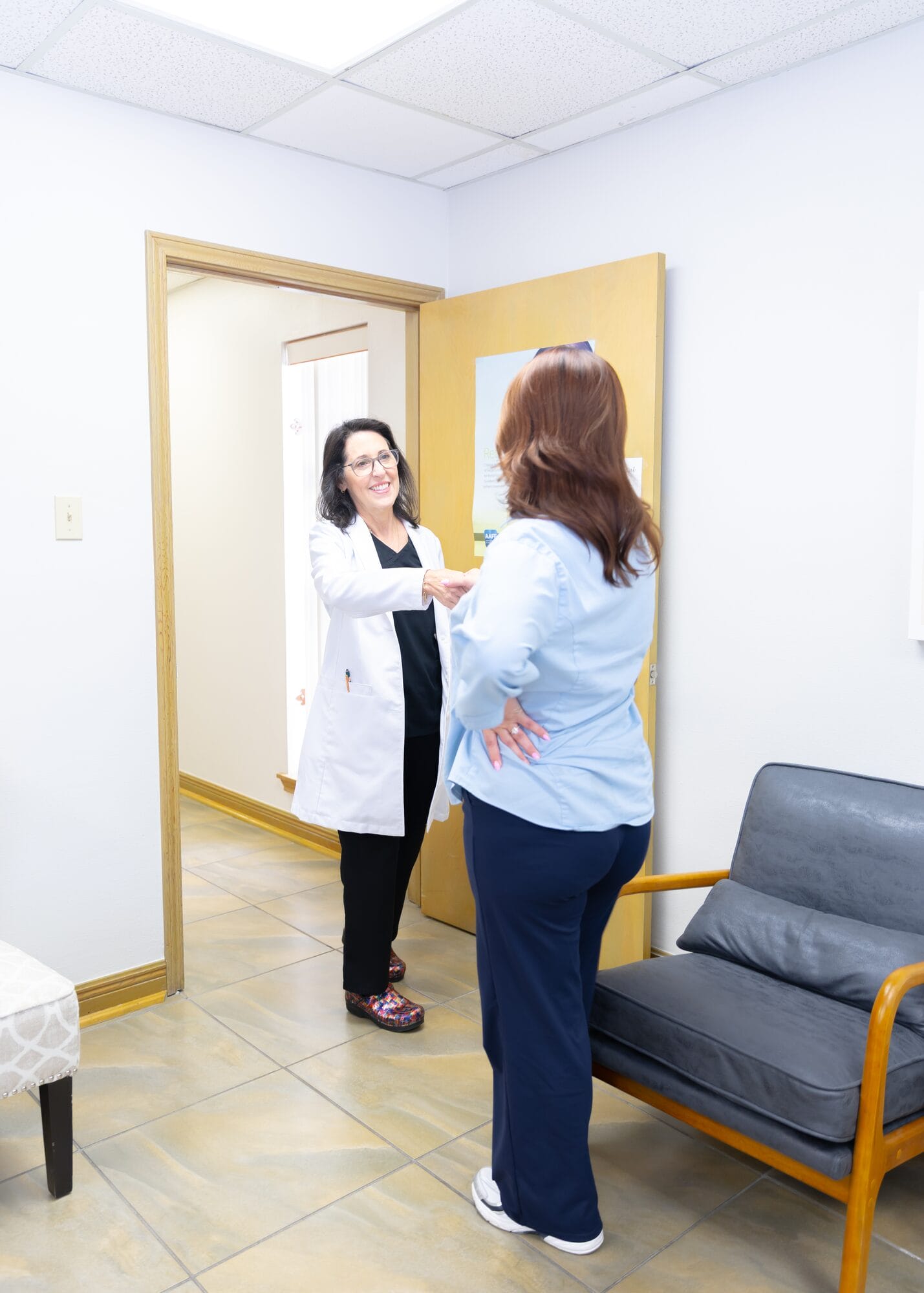 A Barataria Dental dentist talking with a patient in the consultation room
