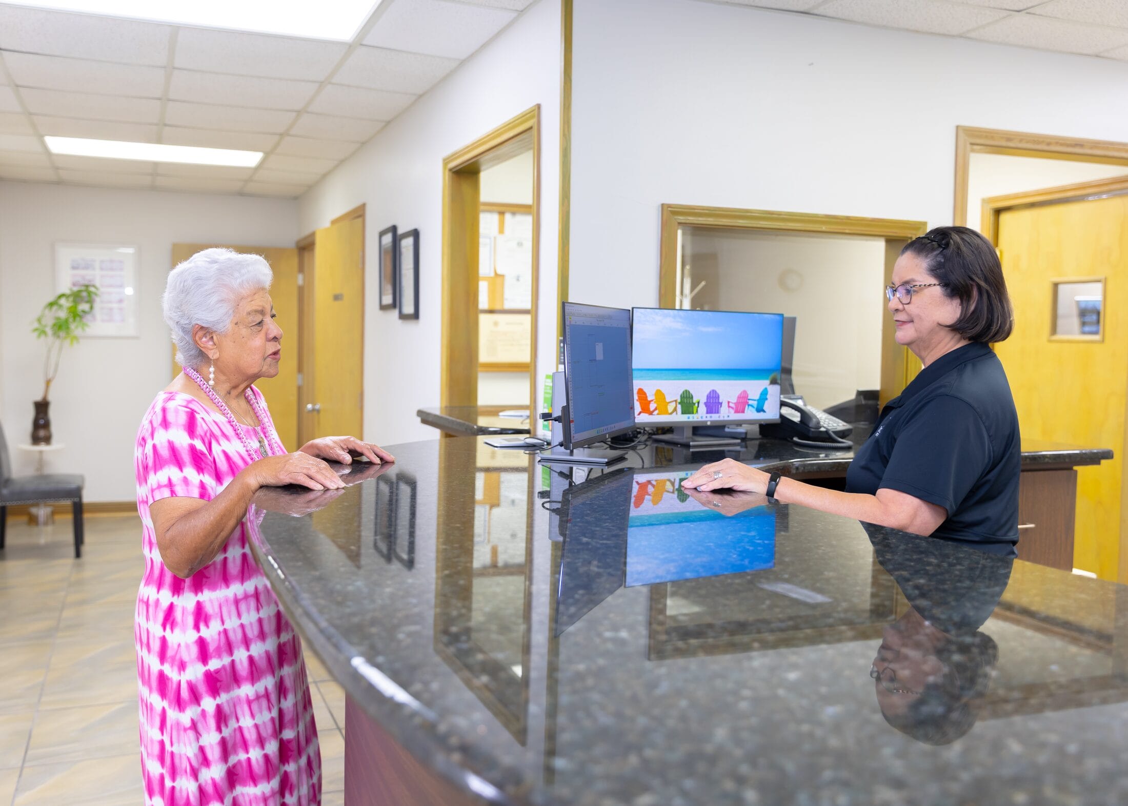 A Barataria Dental team member welcoming a patient at the front desk